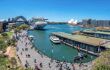 Sydney harbour from above with the famous bridge and Sydney opera house in the background.