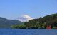 Mt. Fuji and a big red Torii (Gate to the Hakone Shrine) on the Ashinoko Lake under a clear sunny sky. Photoed in Hakone, Japan.