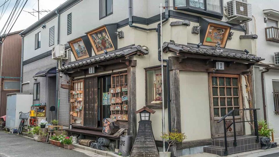 Beautiful facade of Yanaka Emadou traditional restaurant decorated with ema hanging plaques located in Yanaka district.