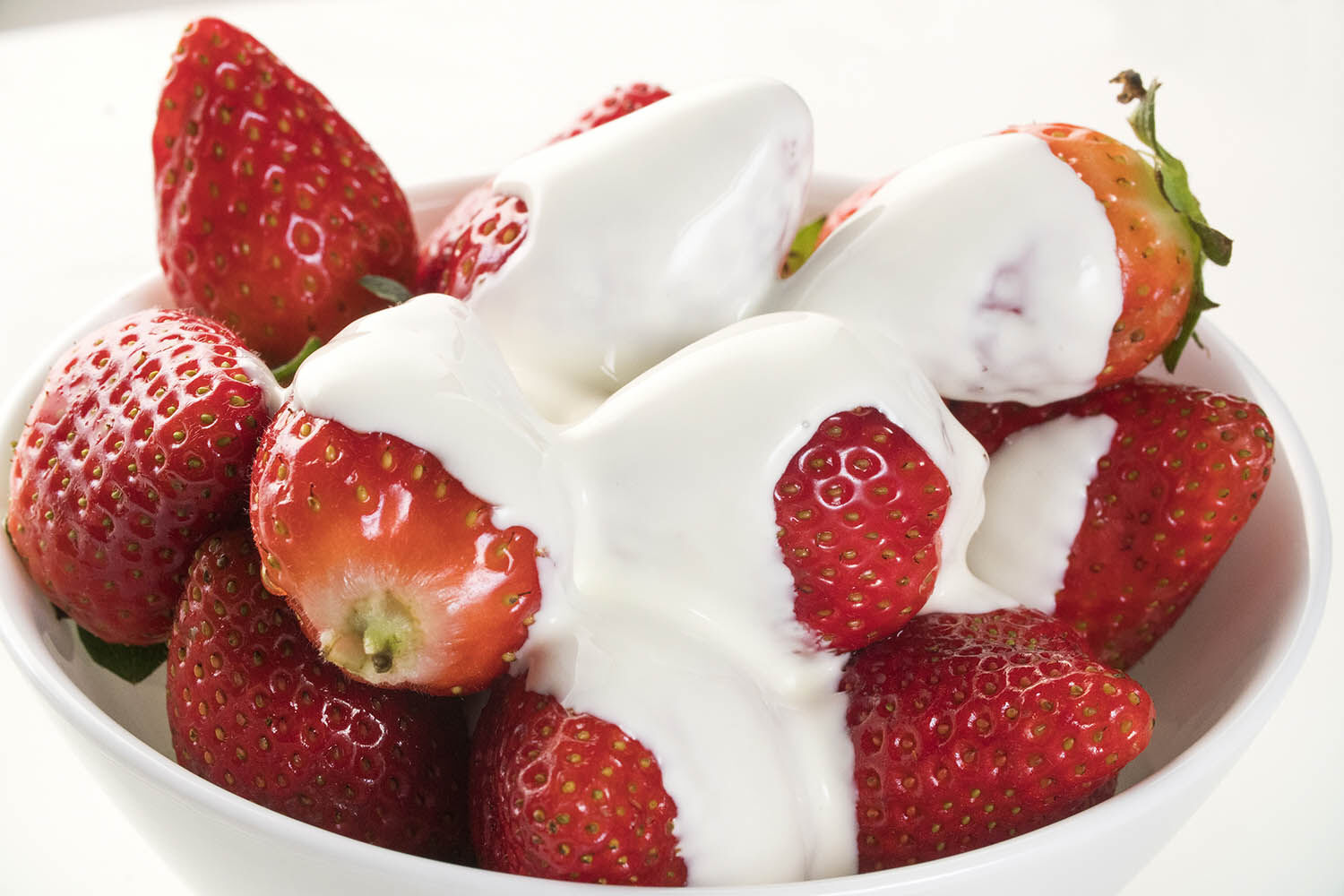 Strawberry with chantilly in white bowl on white background