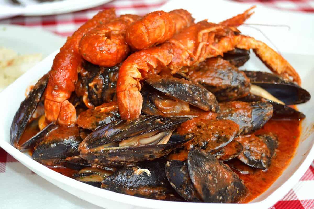 Traditional Croatian seafood - delicious prawns and mussels in red wine buzara sauce