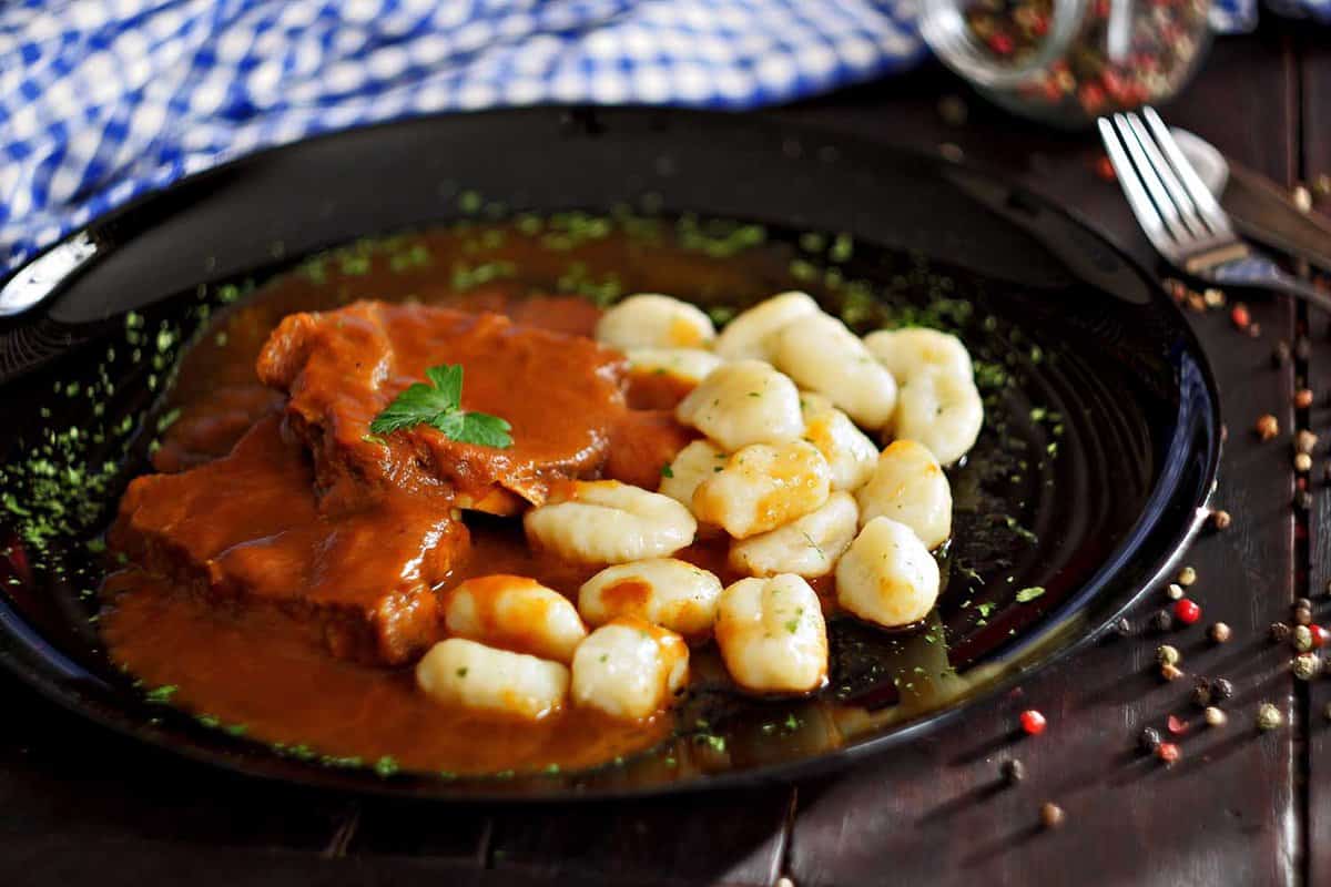 Pasticada with gnocchi, beef stew in a sauce. Croatian cuisine - traditional foods you must try in Croatia
