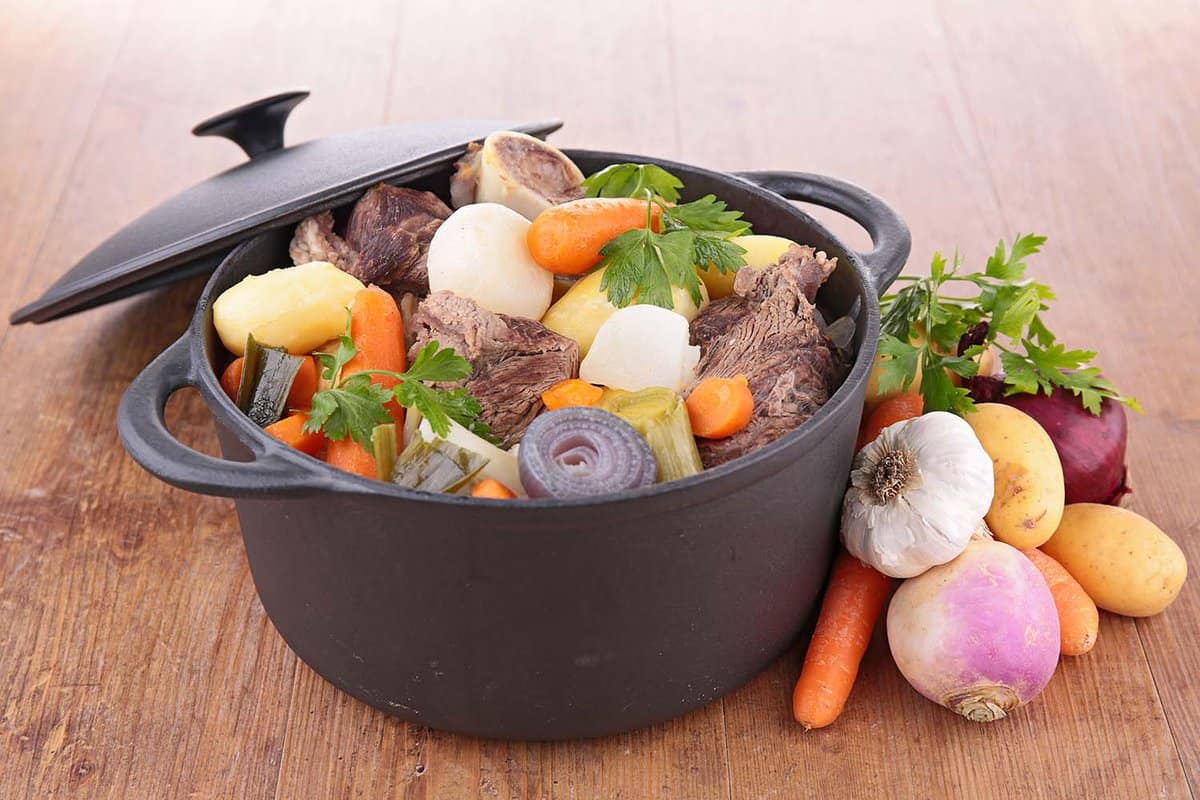 black pot filled with meat and vegetables