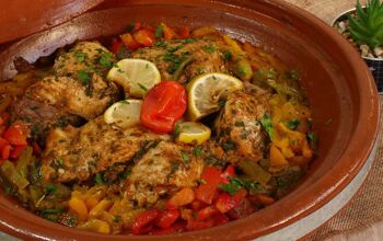Moroccan fish tagine with chermoula, red,yellow and green peppers and preserved lemon close up.