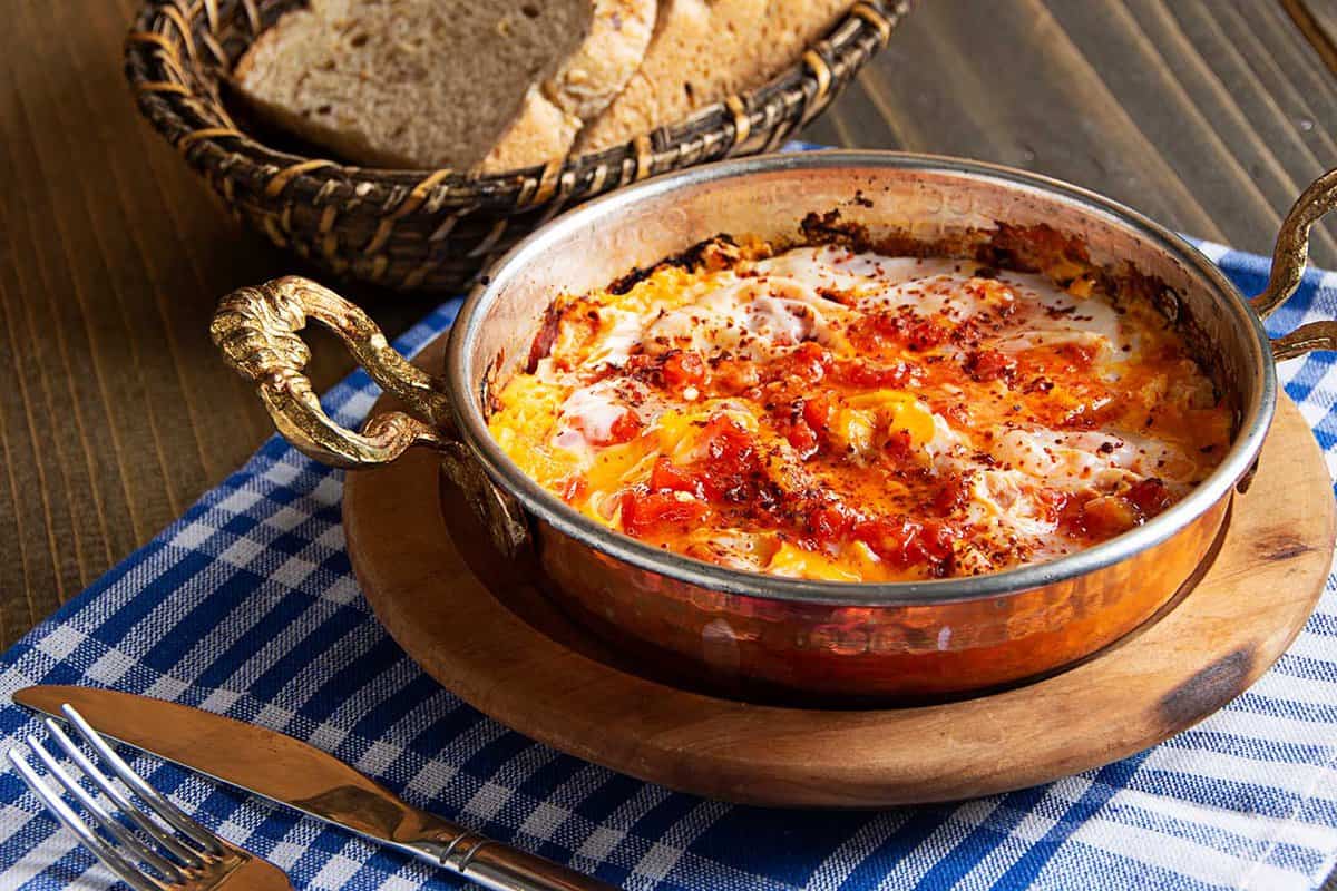Traditional turkish food menemen, made by eggs, tomatoes, sesame and various spices.
