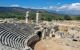 Ruins of an ancient amphitheatre with a blue sky above