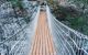 Hanging wooden bridge going across the canyon