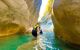 People wading through shallow water along the Lycian trail