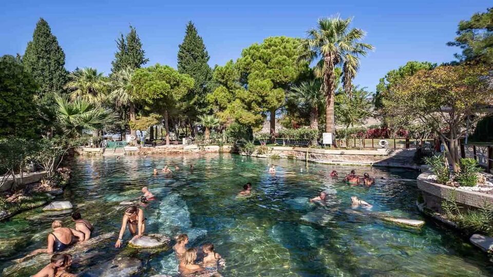 People swimming in outdoor natural pool