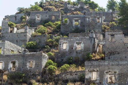Abandoned houses and ruins of Kayakoy village on a hillside