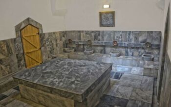 Dark marble bathroom with multiple sinks