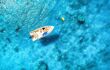 Aerial view of the boat in clear blue water at sunny day in summer