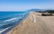 Beautiful sandy beach by the turquoise coloured sea, with sunbeds