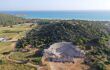 Aerial view of ancient Roman theatre with the sea in the distance