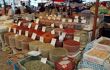 Market stall with bags filled with spices for sale
