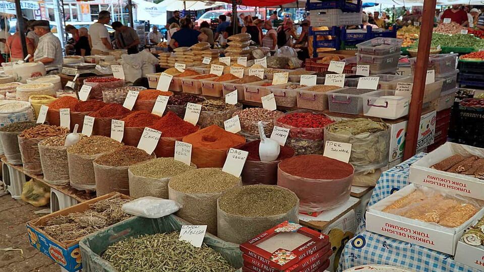 Market stall with bags filled with spices for sale