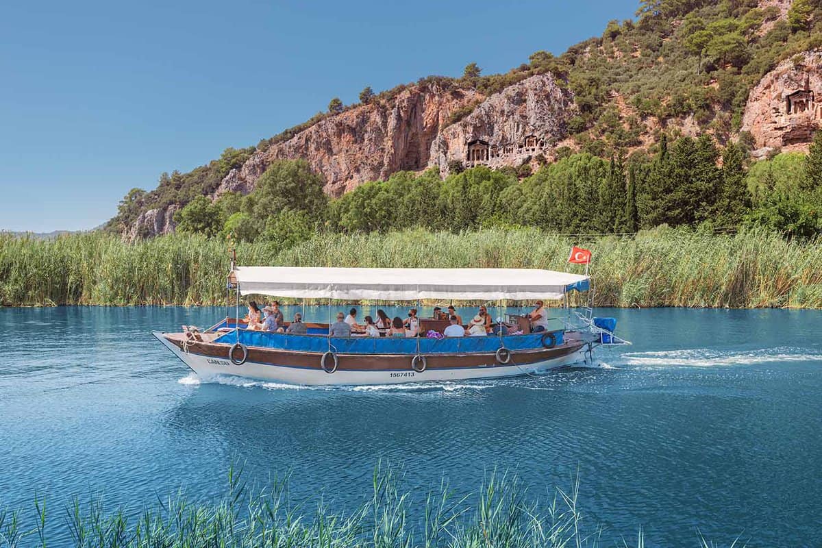 A traditional fishing boat transporting passengers along the beautiful river