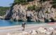 Backpacker walking along the beach as part of the hiking trail