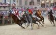 Close up of horses going around a bend in the Il Palio di Siena horserace