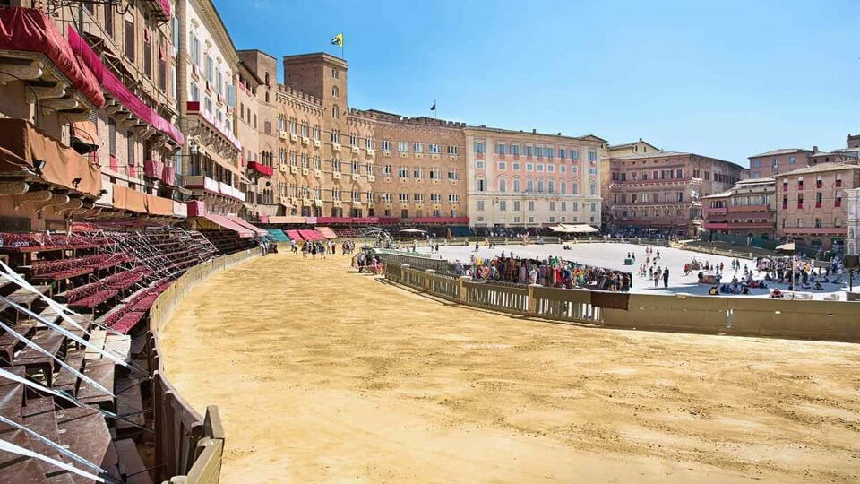 Piazza del Campo in the preparation of the sandy substrate for the place of the Palio horse race, with the Public Palace, Siena, Tuscany, Italy