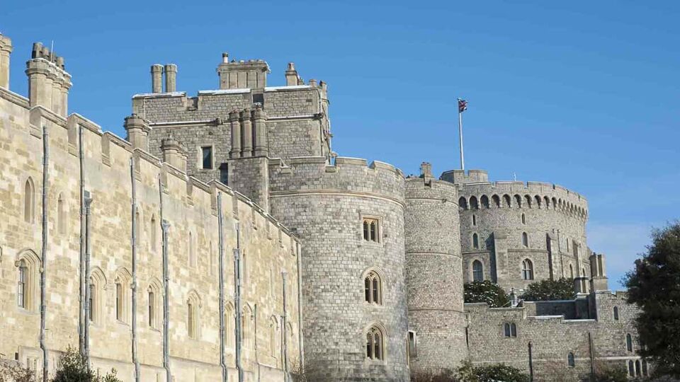A side view of Windsor Castle where the curved structure is prominent of the Middle Ages.