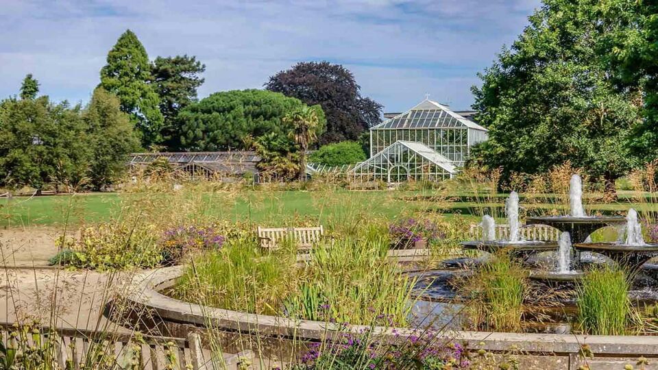 Botanical greenhouse and fountains in garden