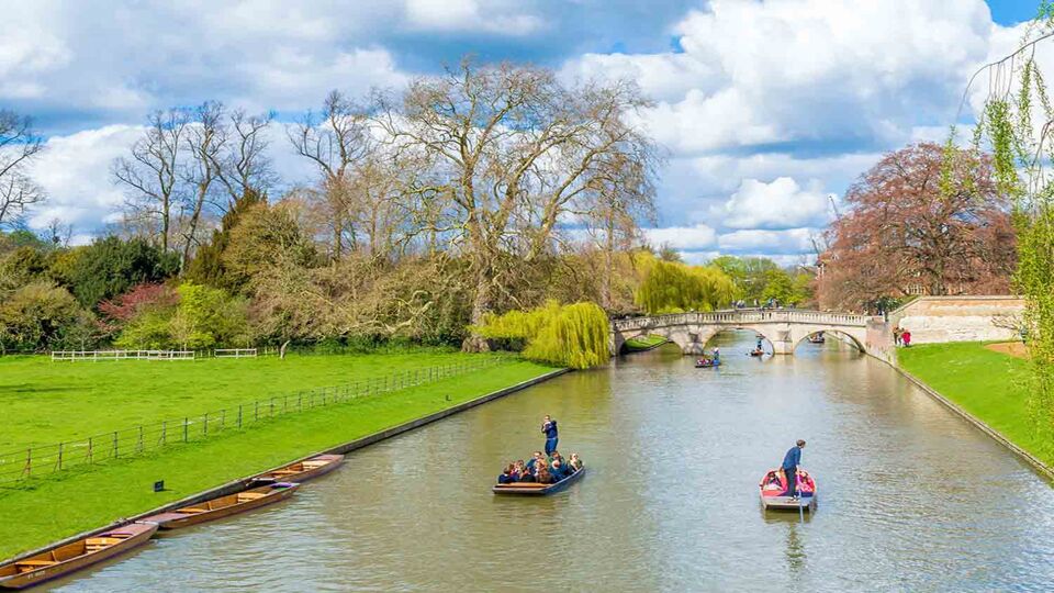Tourist punting at river Cam on a bright sunny day
