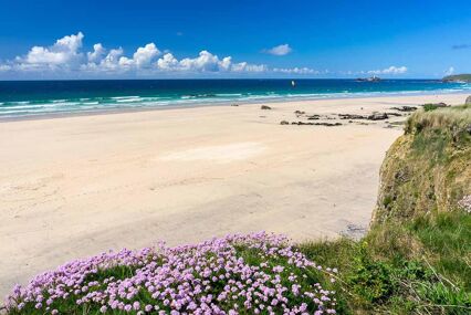 The beautiful golden sandy beach at Gwithian with Godrevy in the distance Cornwall England UK Europe