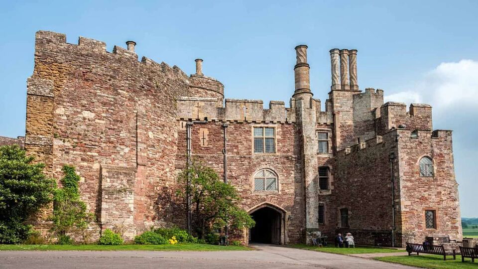 exterior of Berkeley Castle, with red stone walls