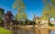 Village scene by the water with lovely stone cottages on the banks