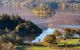 Stunning view of Derwentwater lake with a small wooden boat crossing it