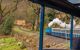 View from out of a carriage of the train to see the steam engine at the front