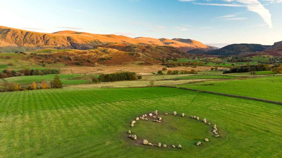 aerial view of a circle of stones in a field
