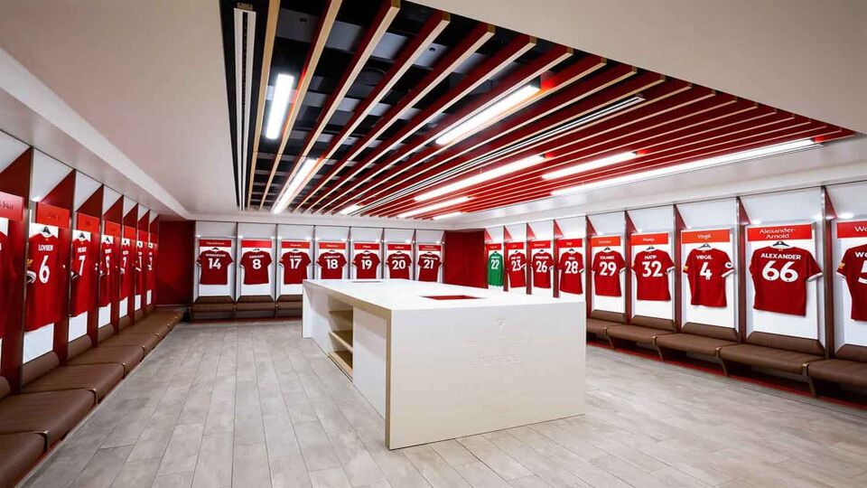 Player's jerseys hung in fornt of lockers in the changing room at Anfield stadium