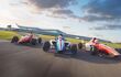 Three racing cars in a circuit competing with the sunset in the background