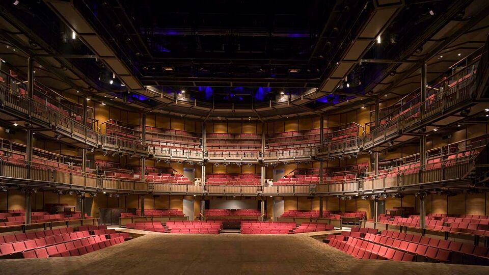 An inside view of the breathtaking Royal Shakespeare Company theatreg Royal Shakespeare Company theatre in Stratford-upon-Avon. Displaying the heightened structured red seats in the