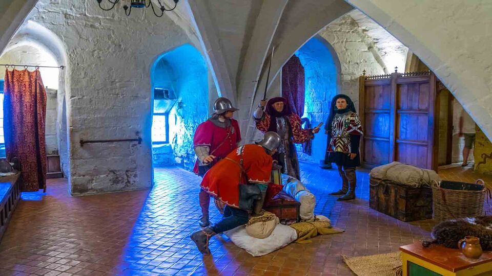 Wax figures enact a medieval scene inside the castle