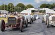 A 1903 vintage 9.2 litre, four cylinder Mercedes Benz 60 HP with red and gold paintwork at the Festival of Speed. Leading the line up of other classics on the grid