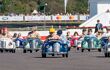 A panoramic wide view of kids in their colourful Austin J40 pedal cars: Settrington Cup, Revival. Harry Dark (no. 2) leads the field to win in his red car