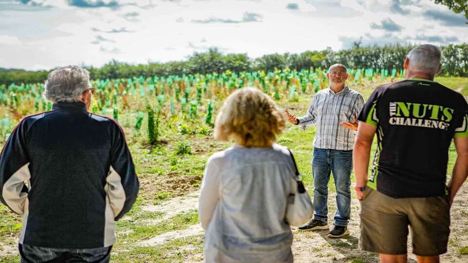 man giving a talk in a vineyard