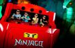 Four excited kids riding the LEgo Ninjago ride, wearing the 4D glasses