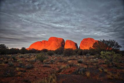 View of the olgas shining bright red in the sunrise