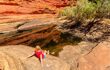 woman relaxes in natural pool in the canyon
