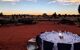 A linen covered table at sunset