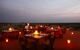 Tables in candlelight at sunset in the desert.