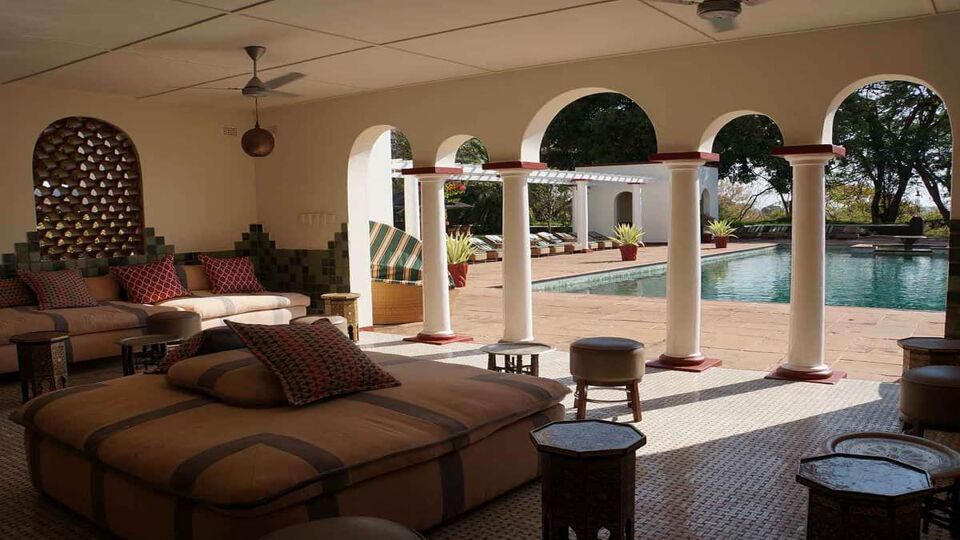 The interior and exterior patio looking out onto a pool