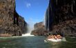 small raft The Zambezi river with a backdrop of the Victoria Falls Waterfall