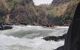 A close up of the white-water with a raft about to go down some rapids