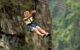 A woman with her legs in the air on the zip-line across the Zambezi