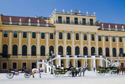 Horse and carts wait outside the palace entrance in the snow